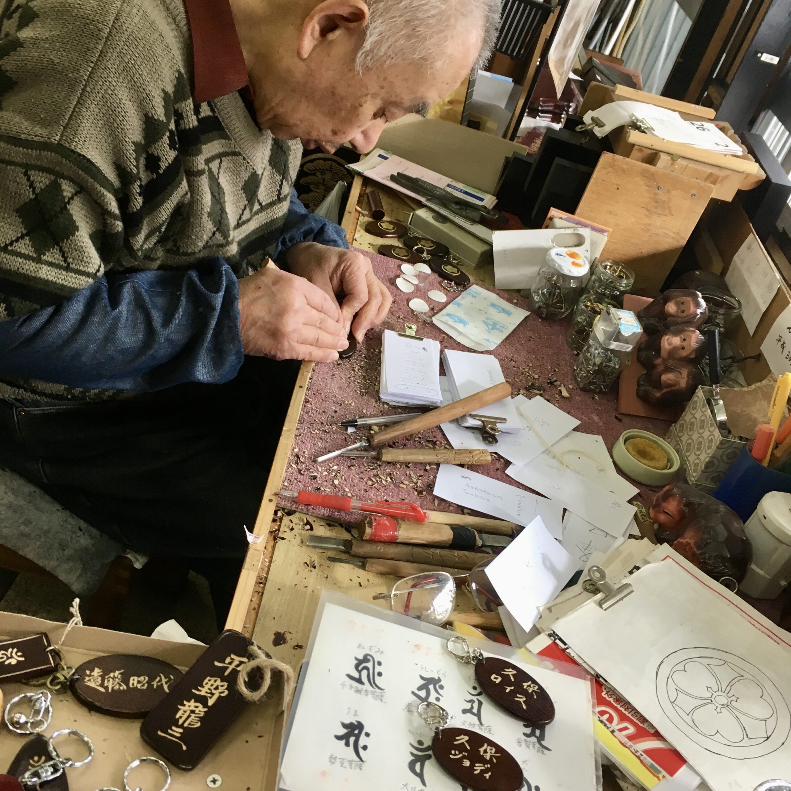 Japanese craftsman carving Kubo name into traditional lacquerware